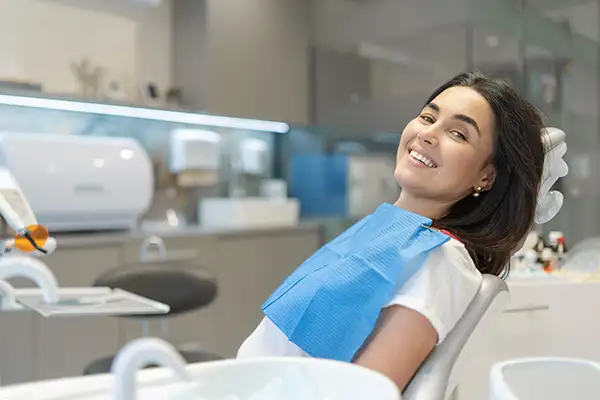 Happy patient sitting in the chair at dental clinic Happy patient sitting in the chair at dental clinic