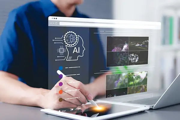 Person using an image generation tool with tablet and laptop Person using an image generation tool with tablet and laptop