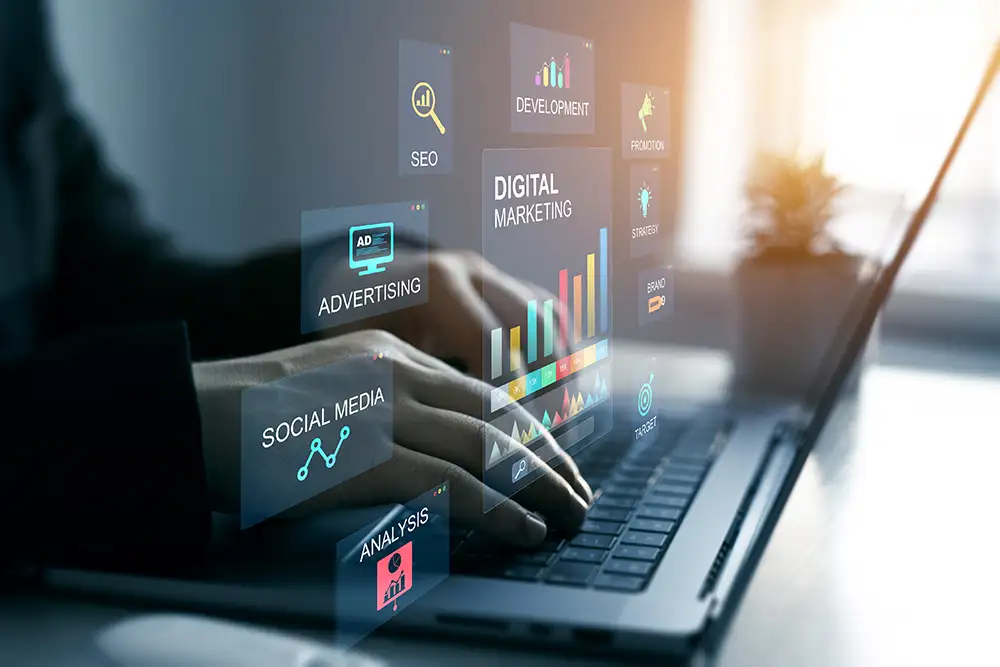 Hands typing on laptop with digital marketing screens Hands typing on laptop with digital marketing screens